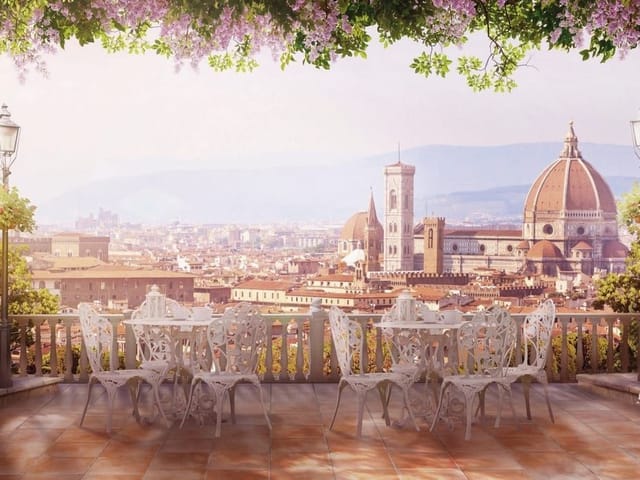 Fototapeta przedstawiająca taras z białymi meblami i widokiem na kopułę katedry