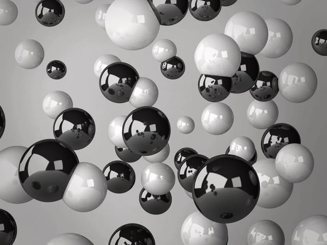 Fototapeta z czarno-białymi kulkami w przestrzeni na szarym tle