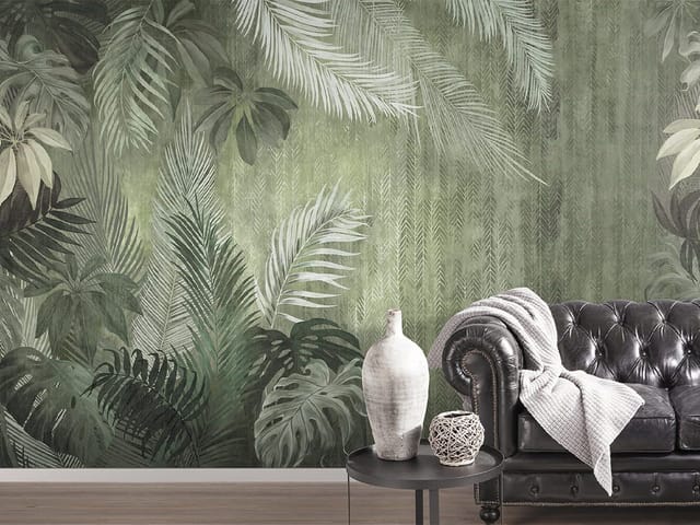 Fototapeta z dużymi liśćmi tropikalnych roślin na zielonym tle