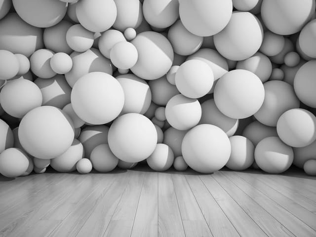 Fototapeta z motywem 3D – ściana z dużymi białymi kulami i drewnianą podłogą