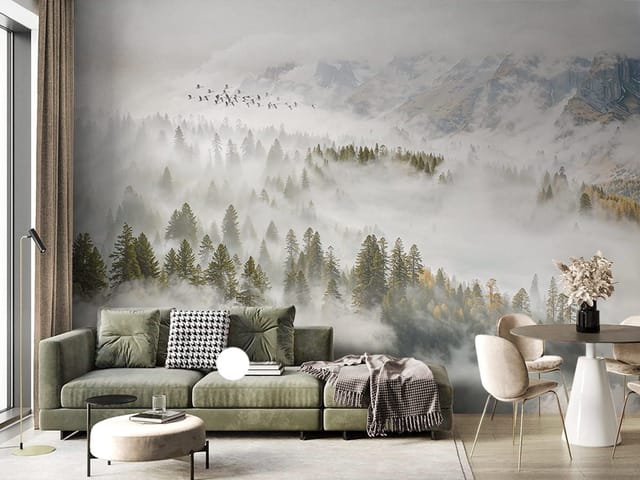 Fototapeta przedstawiająca gęsty las iglasty spowity mgłą z górami w tle.