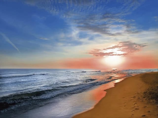 Fototapeta z plażą o zachodzie słońca, spokojne fale i kolorowe niebo