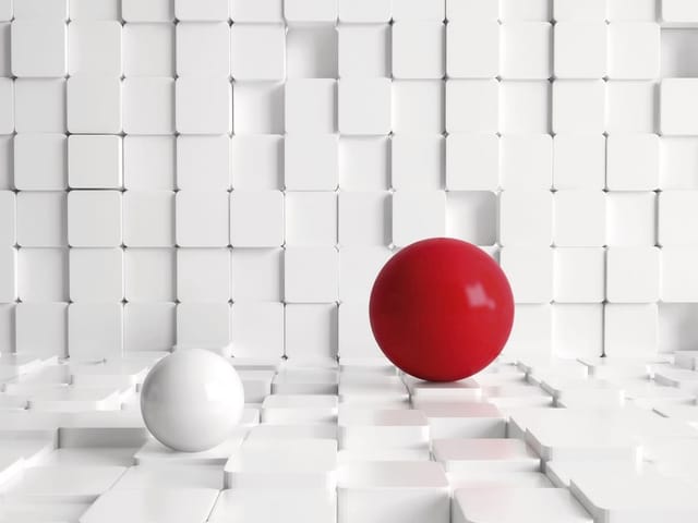 Fototapeta z czerwonymi i białymi kulami na tle geometrycznych bloków
