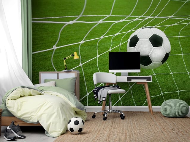 Fototapeta z piłką nożną w siatce bramki na tle zielonej murawy