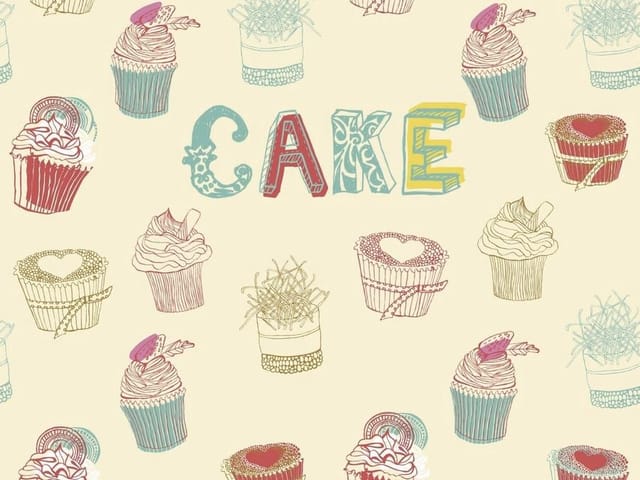 Fototapeta z kolorowym napisem 'CAKE' i babeczkami na jasnym tle
