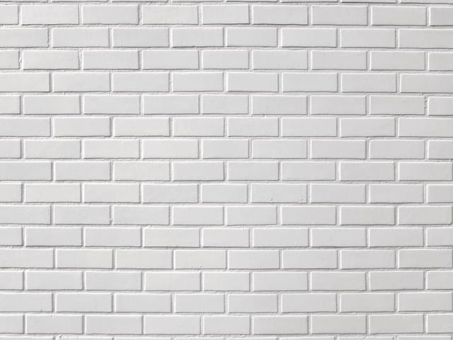Fototapeta z białą ceglaną ścianą i regularnym wzorem cegieł