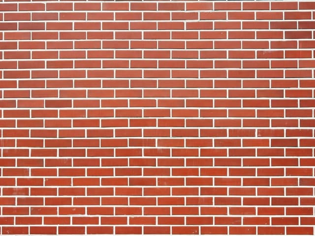 Fototapeta z motywem ściany z czerwonej cegły i białymi fugami