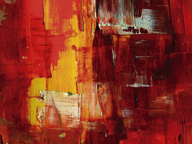 Fototapeta z abstrakcyjnymi pociągnięciami pędzla w czerwieni i żółci