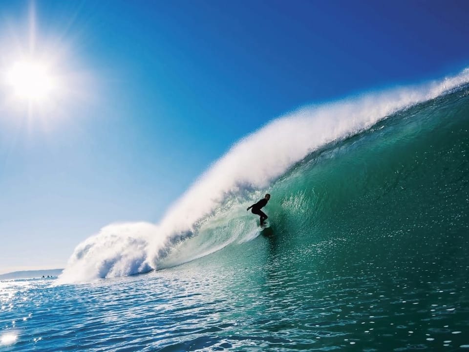 Fototapeta Surfer na fali pod błękitnym niebem na wymiar