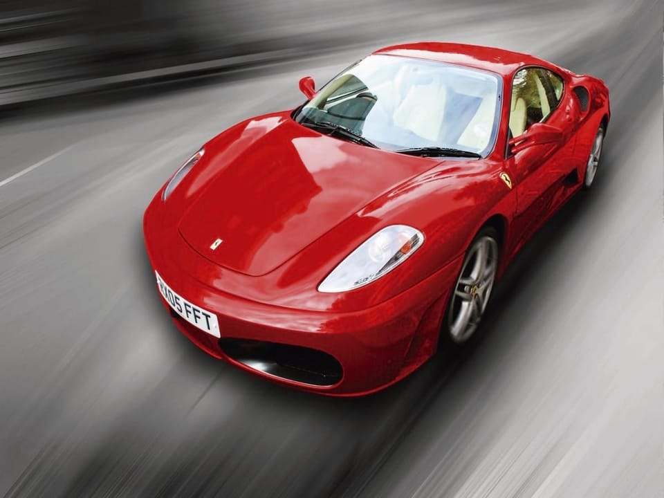 Fototapeta Czerwony sportowy samochód w ruchu