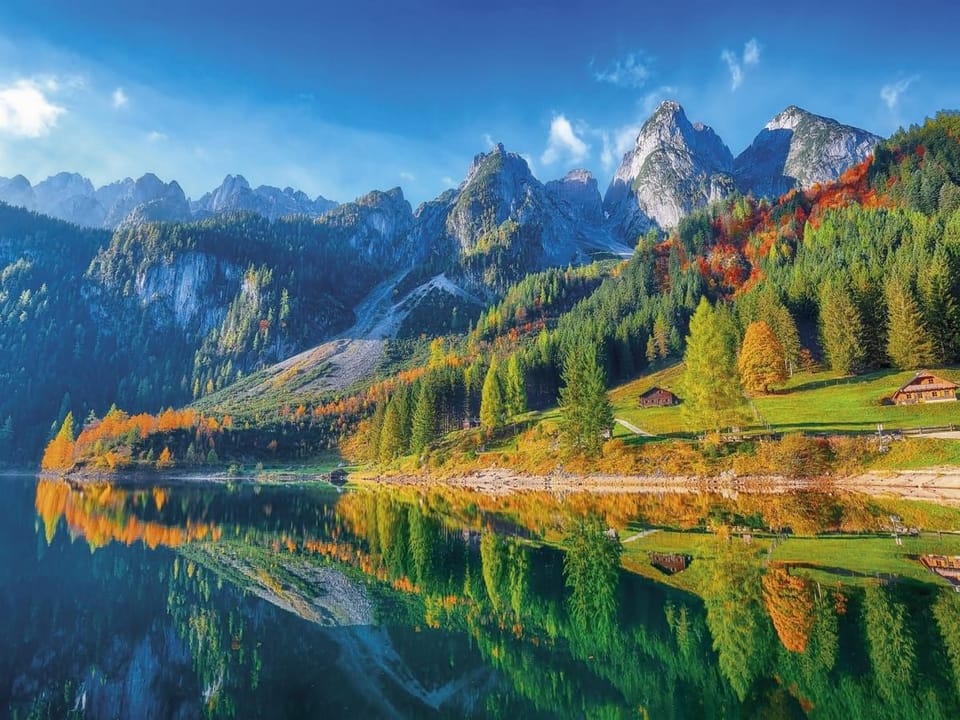 Fototapeta Górski krajobraz z jeziorem i domkami