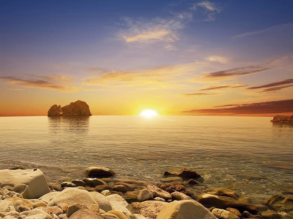 Fototapeta Zachód słońca nad spokojnym morzem