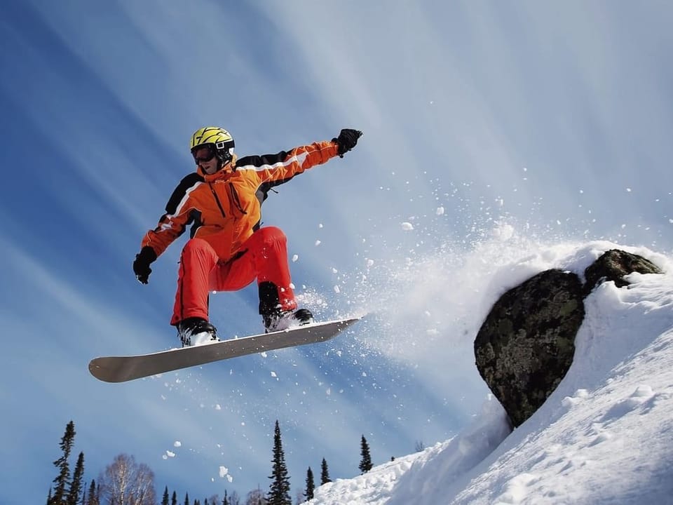Fototapeta Snowboardzista nad śnieżnym stokiem na wymiar