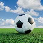 Miniatura fototapety Piłka nożna na tle błękitnego nieba