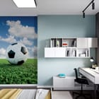 Miniatura fototapety Piłka nożna na tle błękitnego nieba we wnętrzu pokoju nastolatka