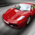 Miniatura fototapety Czerwony sportowy samochód w ruchu