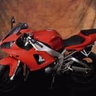 Miniatura fototapety Czerwony motocykl na brązowym tle