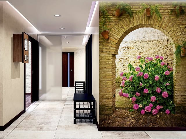 Fototapeta z krzewem hortensji pod kamiennym łukiem i ceglaną ścianą