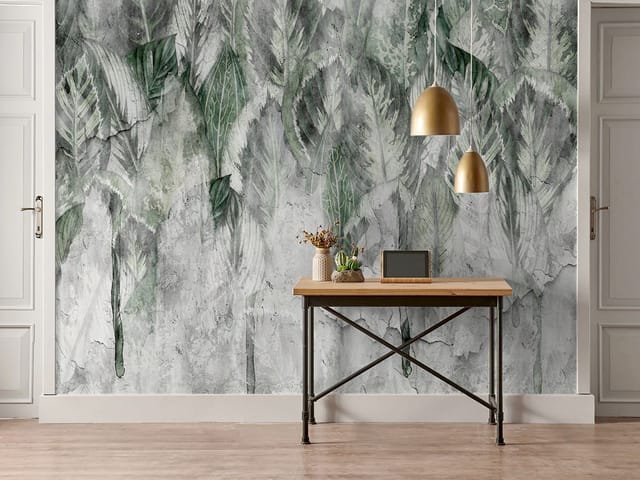 Fototapeta z dużymi zielonymi liśćmi na betonowym tle