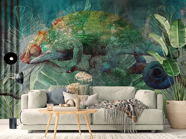 Fototapeta z kameleonem na gałęzi w otoczeniu zielonych liści