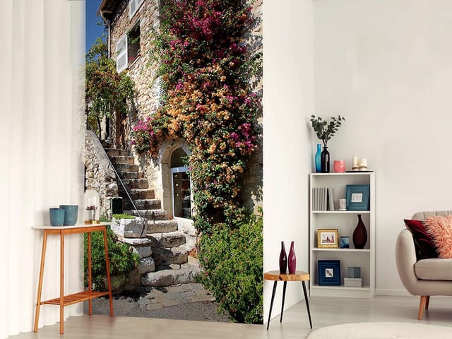 Fototapeta przedstawiająca kamienne schody otoczone zielenią i kwiatami