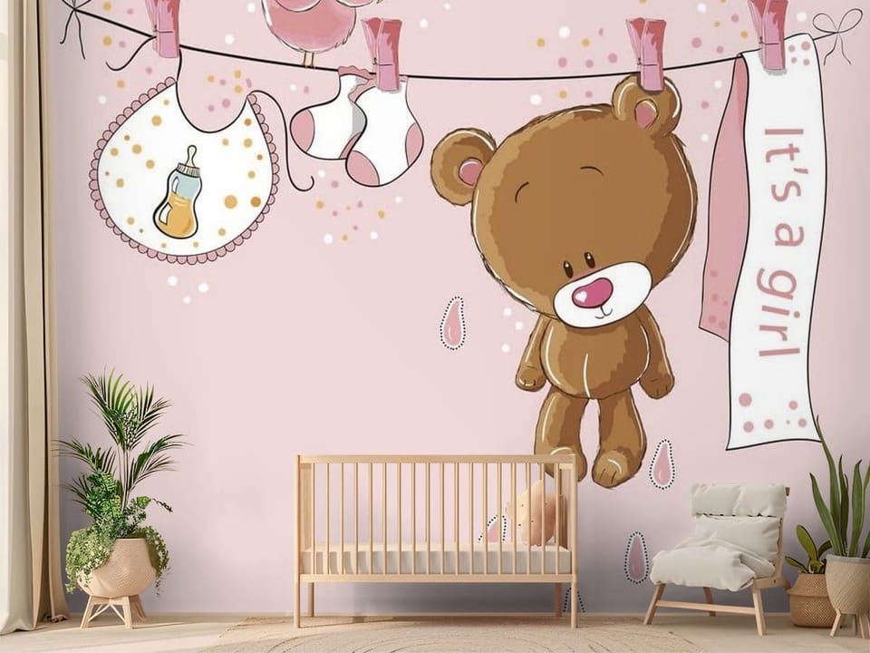 Fototapeta z pluszowym misiem zawieszonym na sznurku i napisem 'It's a girl' - nasłoneczniony pokój dziecięcy