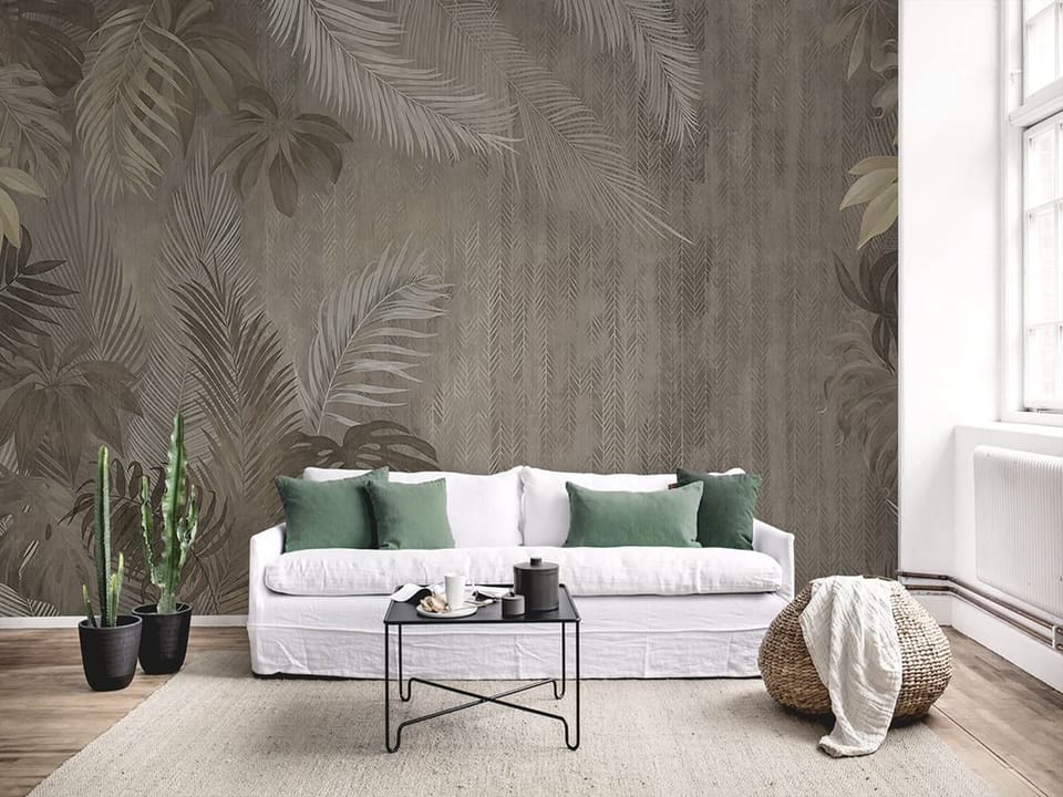 Fototapeta Tropikalne liście na spokojnym tle we wnętrzu salonu