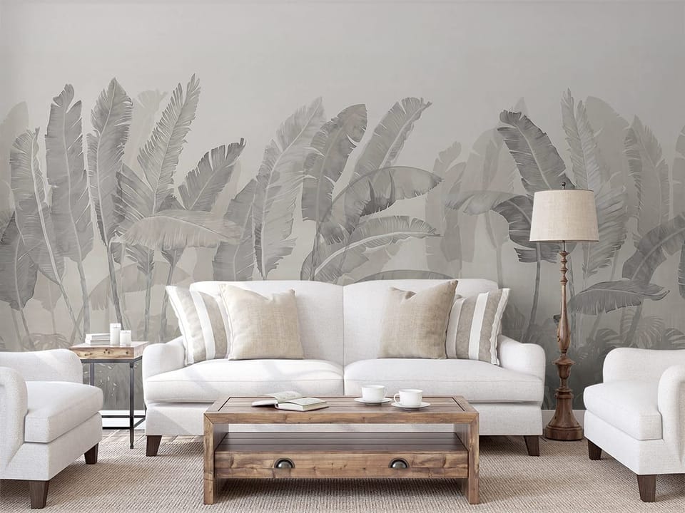 Fototapeta Tropikalne liście na jasnym tle we wnętrzu salonu