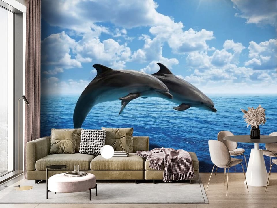 Fototapeta z dwoma delfinami skaczącymi nad błękitną wodą oceanu - ściana akcentowa w salonie z dużym oknem