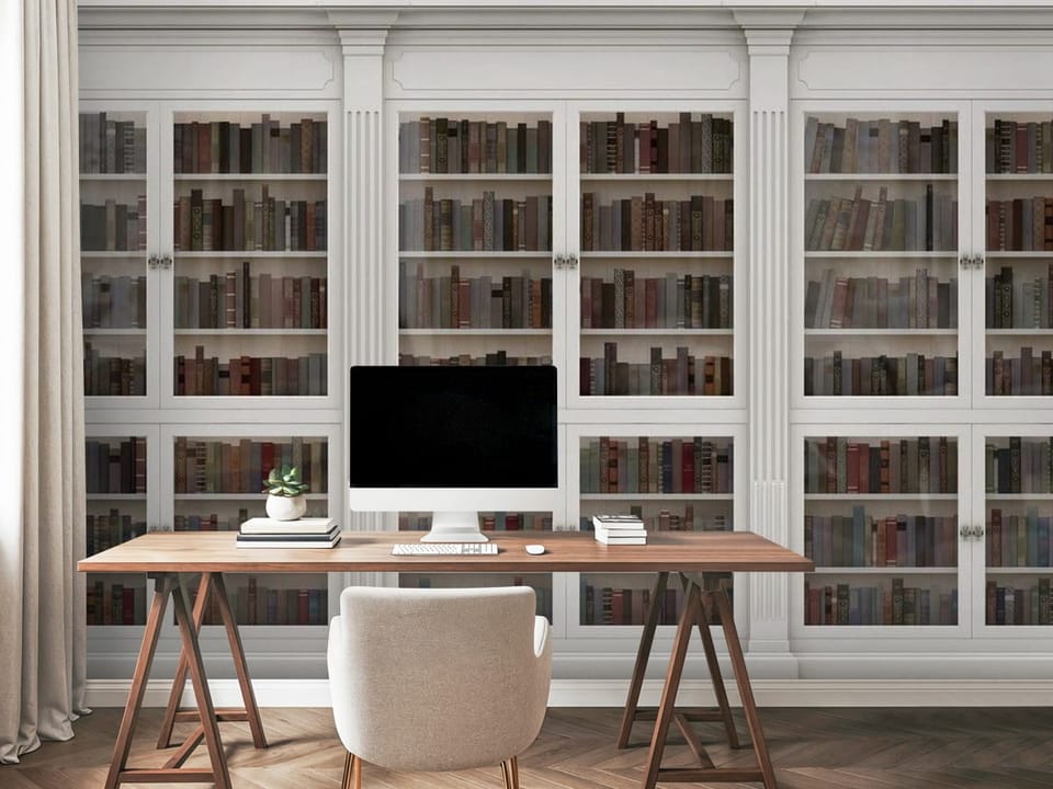 Fototapeta z białą biblioteką z trzema segmentami i kolorowymi książkami - miejsce robocze w biurze