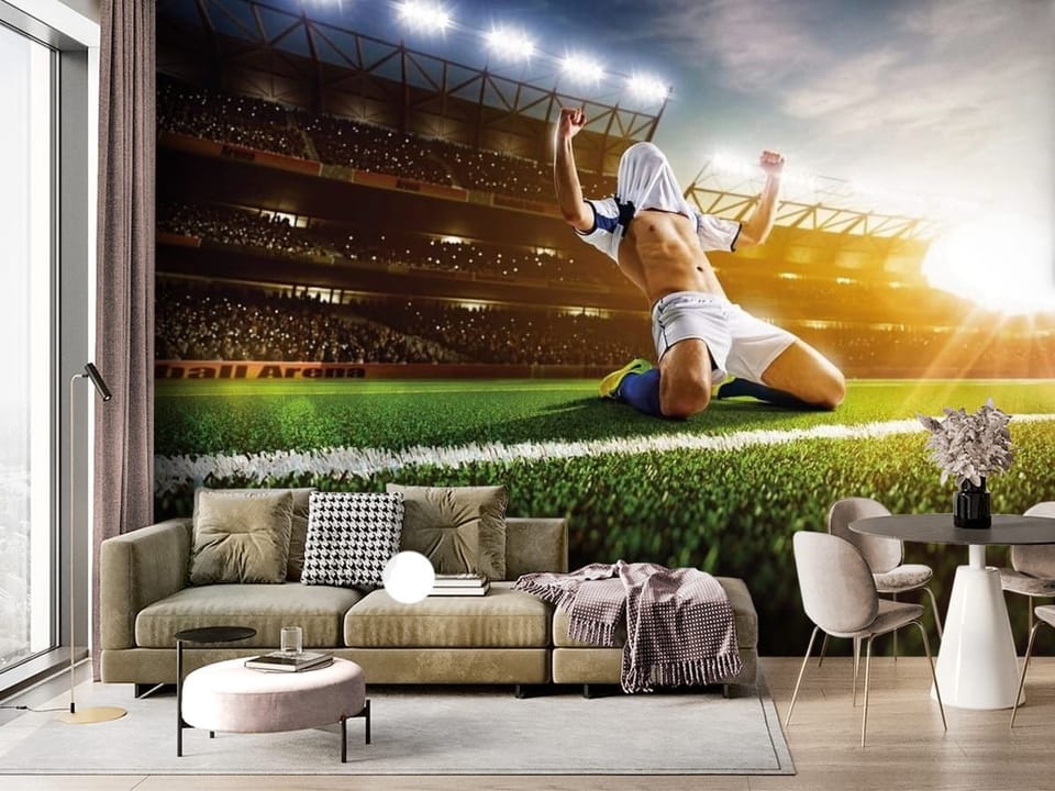 Fototapeta z piłkarzem na kolanach, stadionem i zachodem słońca - ściana akcentowa w salonie z dużym oknem