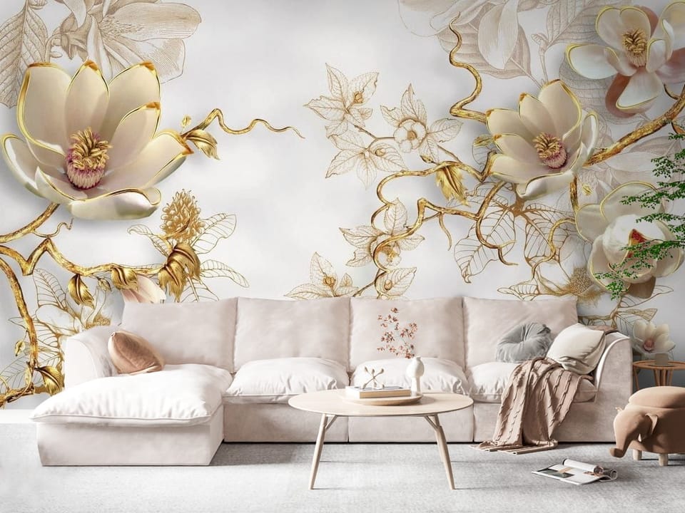 Fototapeta z dużymi kwiatami magnolii na złotych gałęziach i jasnym tle - widok na ścianę w eleganckim salonie