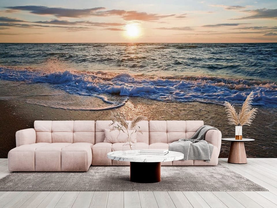 Fototapeta z zachodzącym słońcem, falami i piaskiem na plaży - salon w jasnych kolorach
