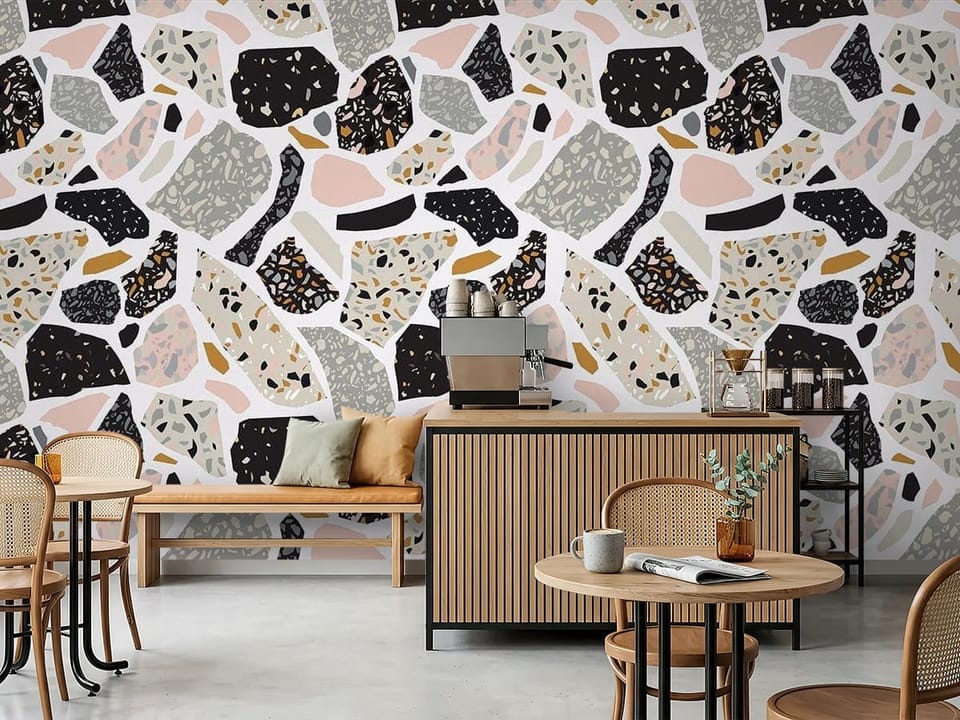 Fototapeta z wzorem terrazzo w kolorach czarnym, szarym i różowym na jasnym tle - inspiracja do nowoczesnej kawiarni