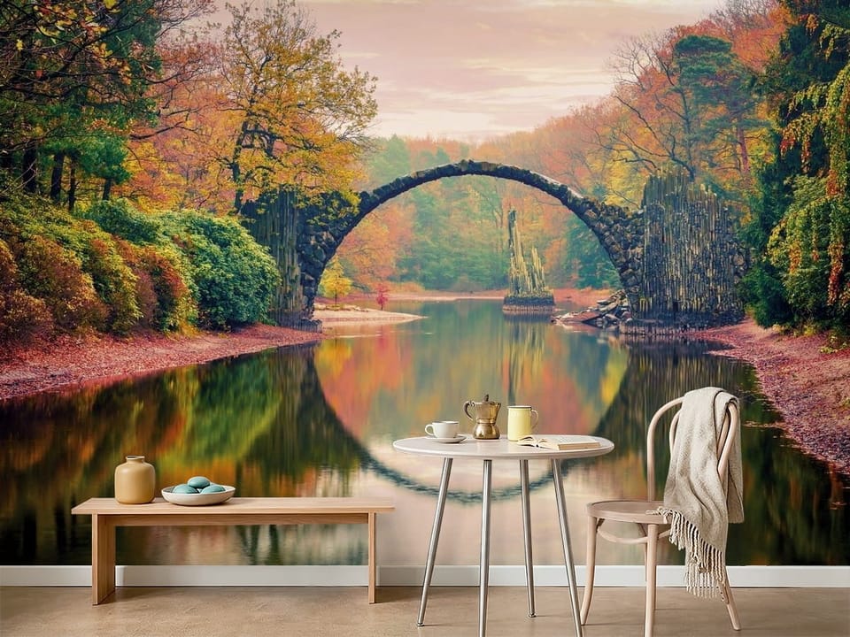 Fototapeta z kamiennym mostem nad wodą i jesiennym krajobrazem - ściana w minimalistycznej kawiarni