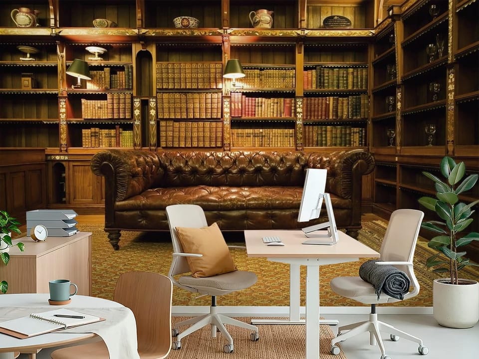 Fototapeta z regałami książkowymi i skórzaną kanapą w bibliotece - aranżacja biura w jasnych kolorach