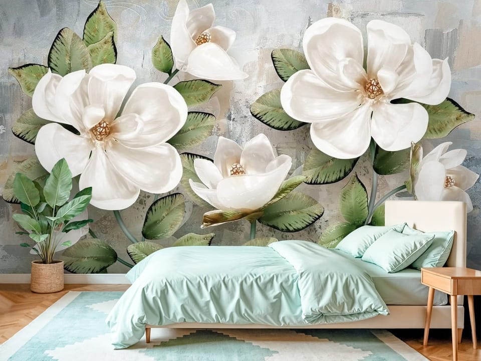 Fototapeta z dużymi białymi kwiatami magnolii i zielonymi liśćmi - piękna inspiracja do sypialni