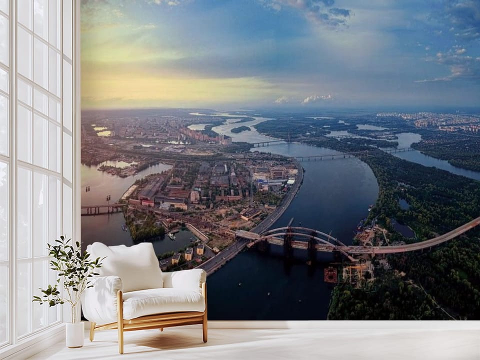 Fototapeta przedstawiająca panoramę miasta z szeroką rzeką i mostami o zachodzie słońca - pomysłowe wykończenie ściany w przedpokoju